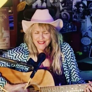 Jerialice playing guitar and singing